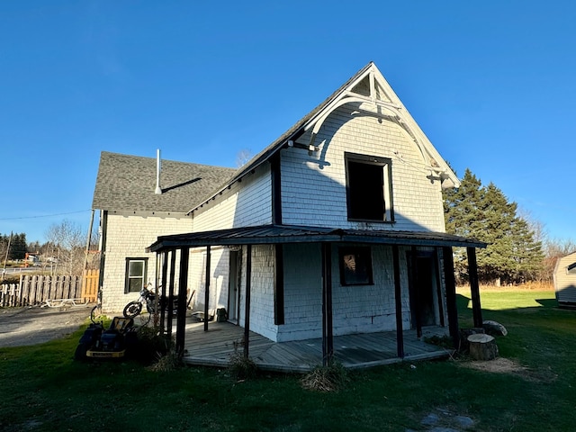 rear view of property featuring a lawn