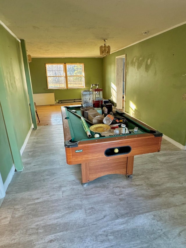 game room with baseboard heating, crown molding, pool table, and light hardwood / wood-style floors