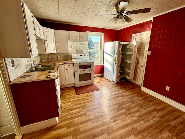 kitchen featuring white appliances, sink, white cabinetry, decorative backsplash, and light hardwood / wood-style flooring