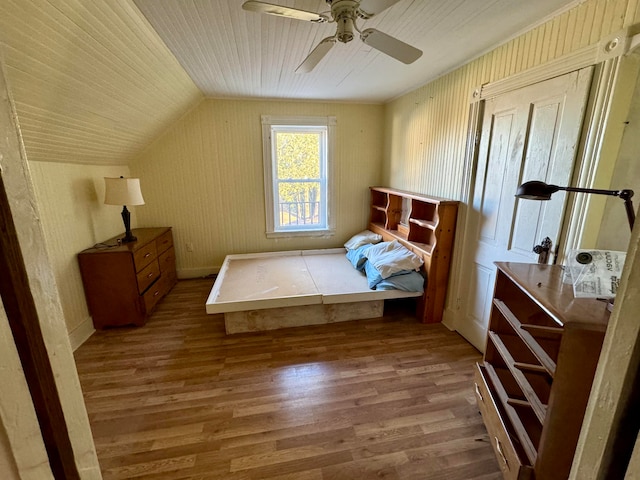 bedroom with ceiling fan, lofted ceiling, and light wood-type flooring