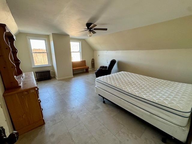 bedroom featuring vaulted ceiling, radiator, and ceiling fan