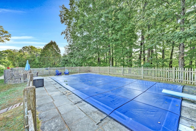 view of pool featuring fence and a patio area