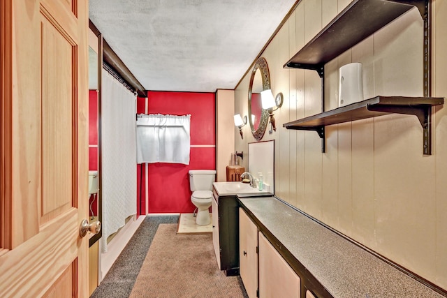 corridor featuring a sink, carpet, and a textured ceiling
