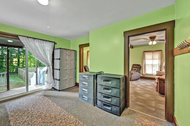 carpeted bedroom with access to outside and ceiling fan