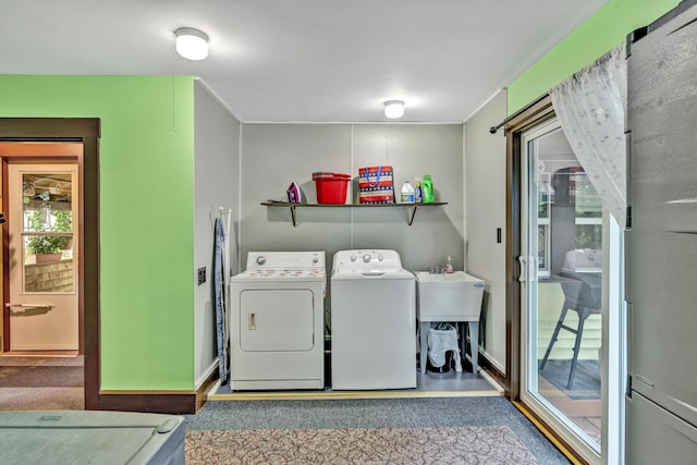 washroom with washer and clothes dryer and baseboards