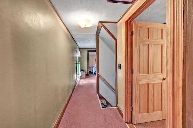 hallway with carpet and baseboards