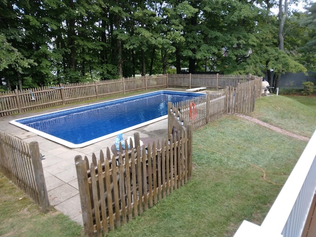 view of swimming pool featuring view of scattered trees