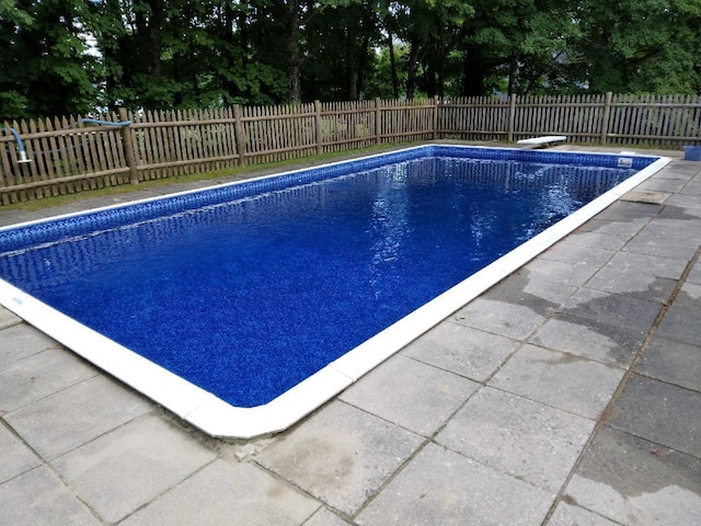 view of pool with a fenced backyard