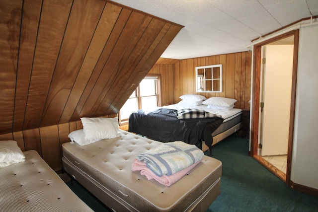 bedroom with lofted ceiling, wooden walls, and dark colored carpet