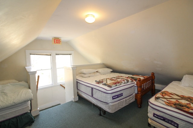 bedroom featuring vaulted ceiling and carpet floors