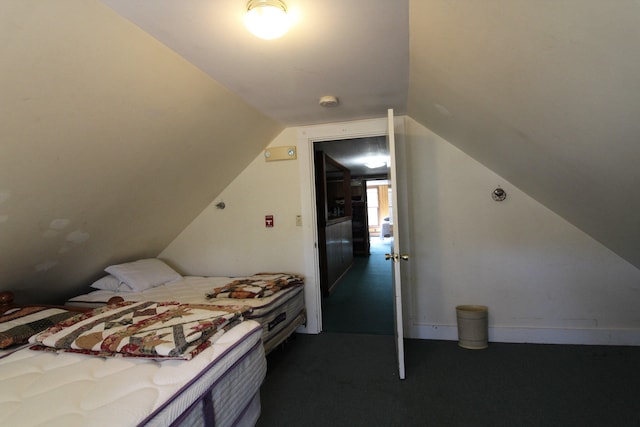 carpeted bedroom featuring vaulted ceiling