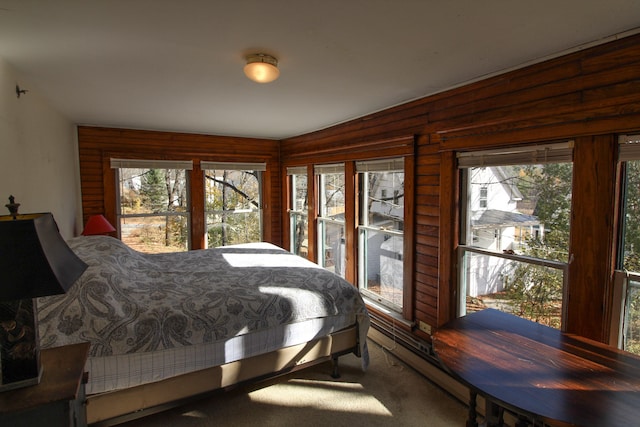 bedroom featuring wood walls and carpet flooring