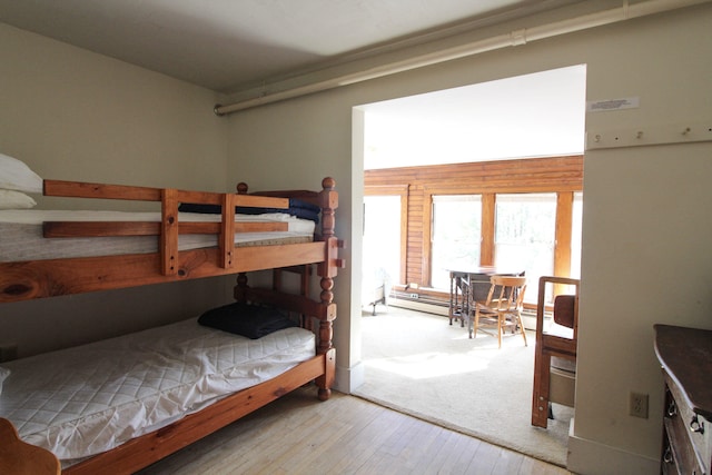 bedroom featuring light hardwood / wood-style floors and wooden walls