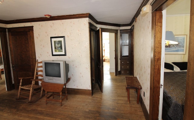 interior space with ornamental molding and dark hardwood / wood-style floors