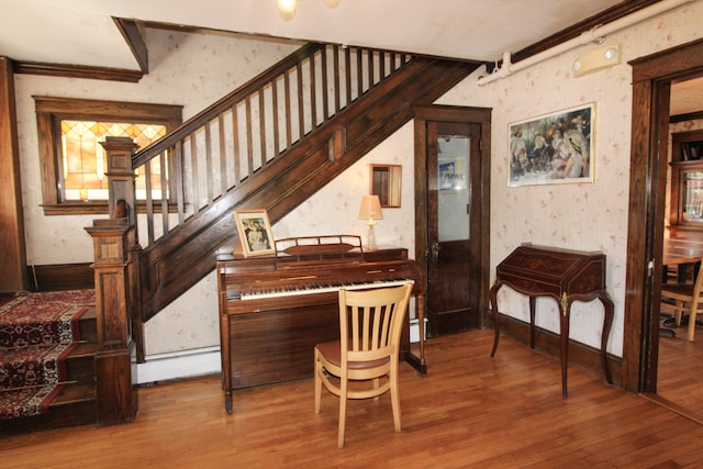 miscellaneous room with wood-type flooring and ornamental molding