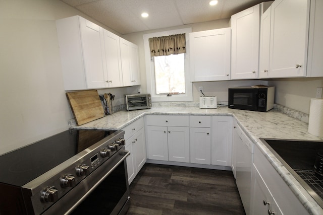 kitchen with white cabinets, light stone countertops, black appliances, and dark hardwood / wood-style floors