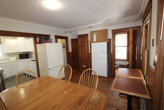 dining area with crown molding and dark hardwood / wood-style floors