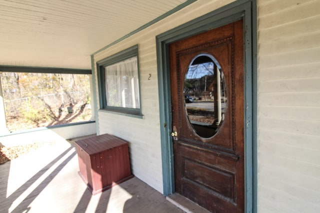 doorway to property featuring covered porch