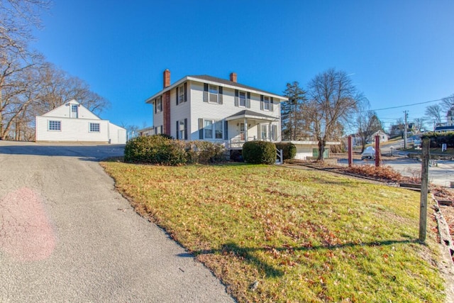 view of front of home featuring a porch and a front lawn