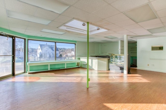 interior space with a fireplace and a paneled ceiling