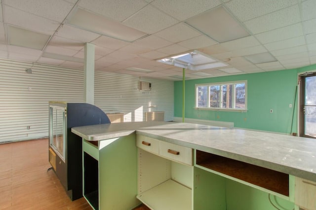 kitchen featuring a drop ceiling and light wood-type flooring