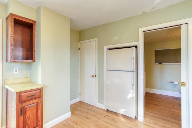 kitchen featuring white fridge and light hardwood / wood-style floors