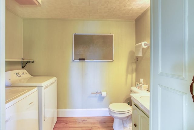 bathroom featuring vanity, hardwood / wood-style floors, toilet, and separate washer and dryer