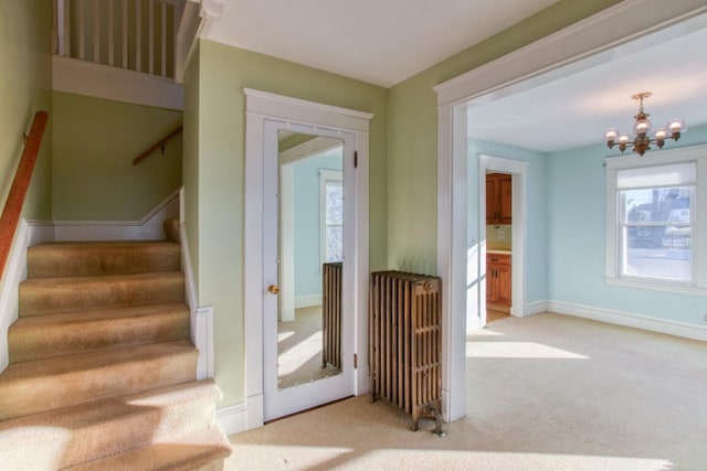 staircase featuring an inviting chandelier and carpet floors