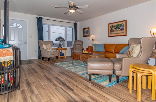 living room featuring hardwood / wood-style floors and ceiling fan