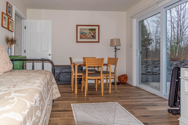 bedroom featuring dark wood-type flooring and access to outside