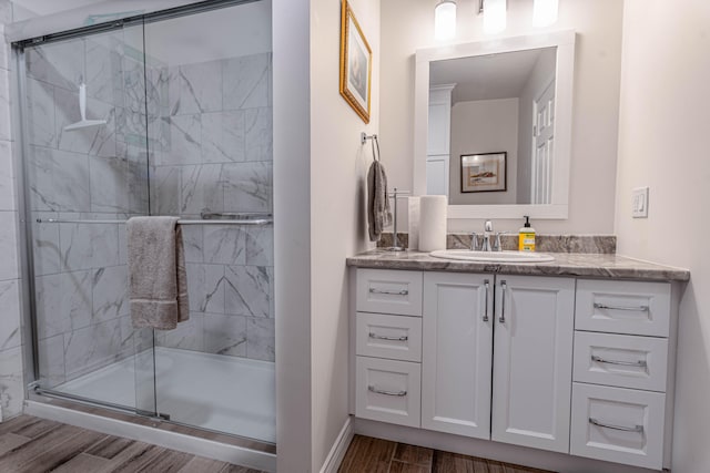 bathroom with vanity, an enclosed shower, and hardwood / wood-style floors