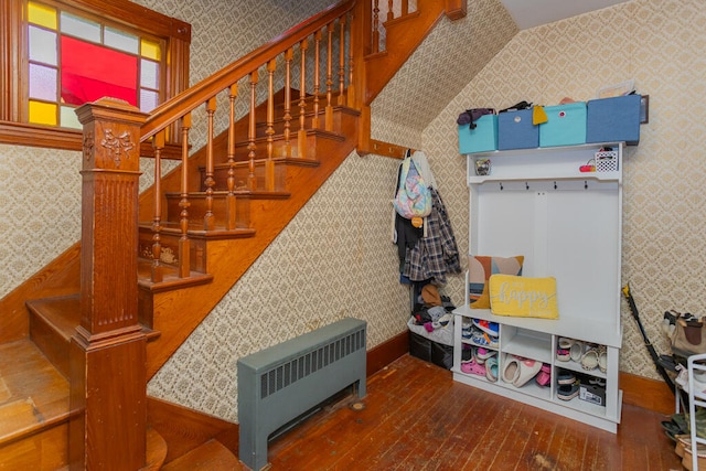 mudroom with radiator heating unit and hardwood / wood-style floors