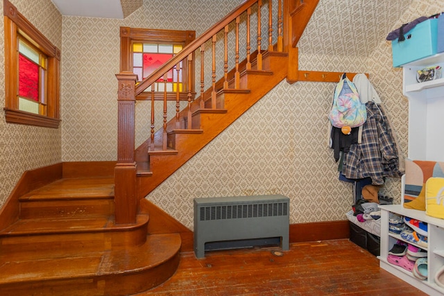 staircase with radiator and wood-type flooring