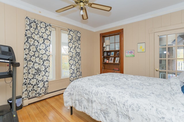 bedroom featuring ceiling fan, crown molding, wood-type flooring, and a baseboard radiator