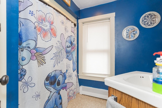 bathroom featuring a baseboard heating unit