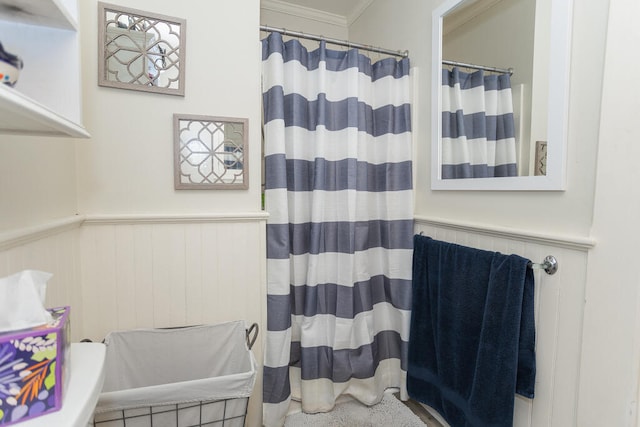 bathroom featuring crown molding and a shower with curtain