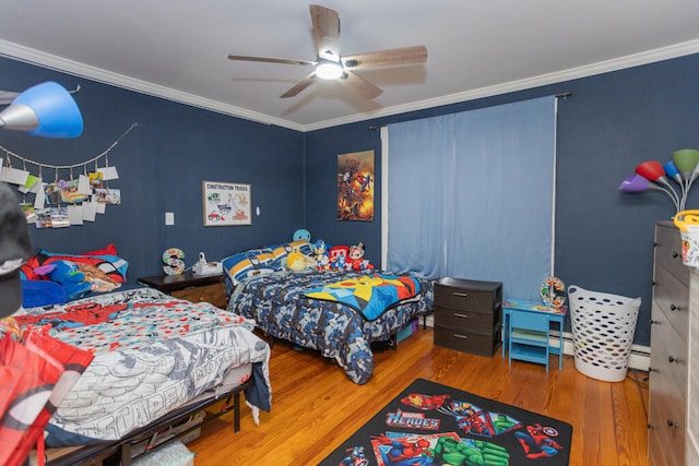 bedroom featuring ornamental molding, hardwood / wood-style flooring, baseboard heating, and ceiling fan