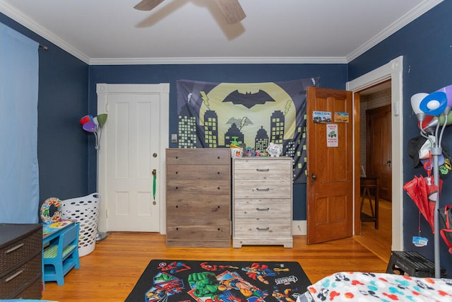 bedroom featuring ornamental molding, hardwood / wood-style flooring, and ceiling fan