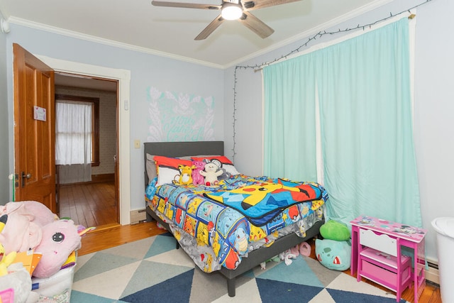 bedroom featuring crown molding, hardwood / wood-style flooring, and ceiling fan