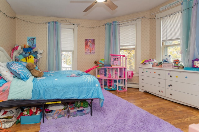 bedroom featuring multiple windows, light wood-type flooring, and ceiling fan