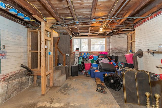 basement featuring brick wall