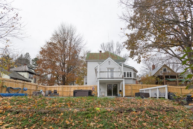 back of property with a balcony