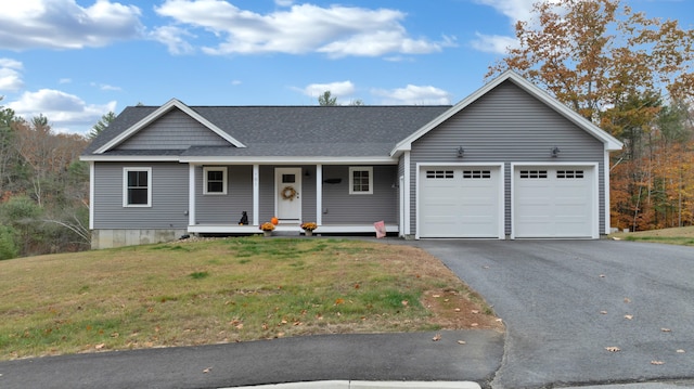 view of front of home featuring a garage, a front lawn, and a porch