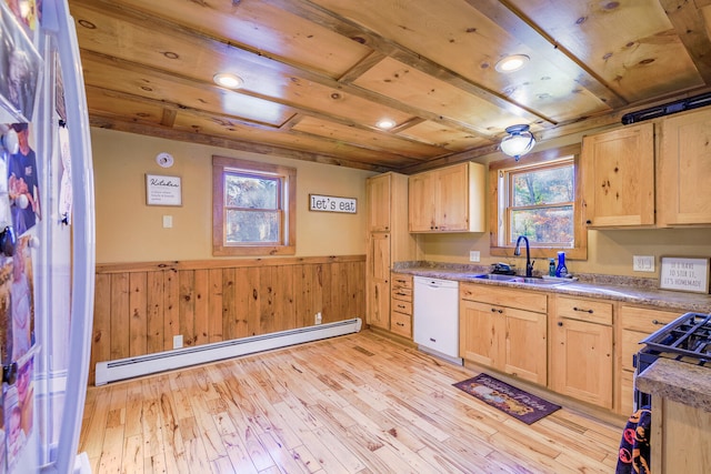 kitchen with baseboard heating, a healthy amount of sunlight, white dishwasher, and light wood-type flooring