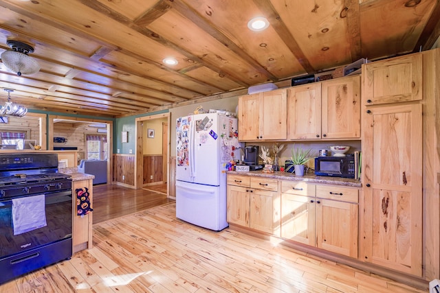 kitchen with light brown cabinets, black appliances, and light wood-type flooring