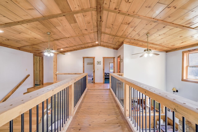 corridor featuring lofted ceiling, light wood-type flooring, and wooden ceiling