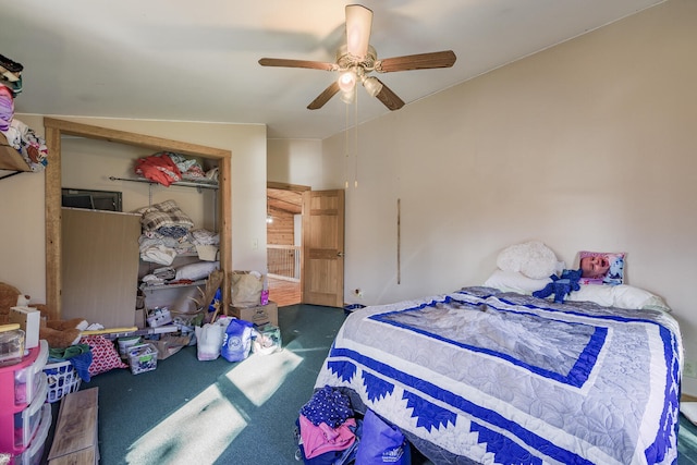 bedroom featuring dark carpet, lofted ceiling, a closet, and ceiling fan