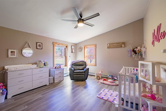 bedroom with lofted ceiling, ceiling fan, a nursery area, wood-type flooring, and baseboard heating