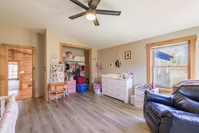 sitting room featuring vaulted ceiling, a healthy amount of sunlight, light wood-type flooring, and ceiling fan