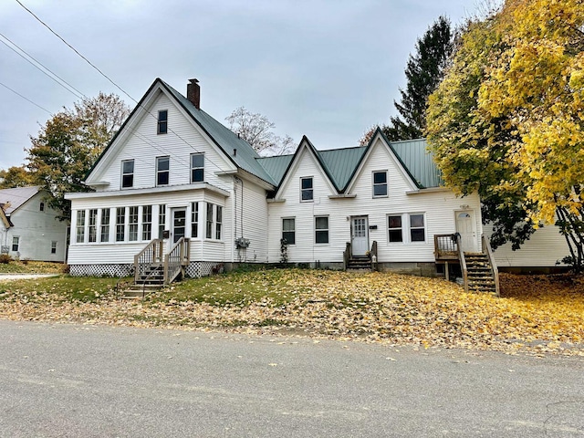 view of front facade with a sunroom